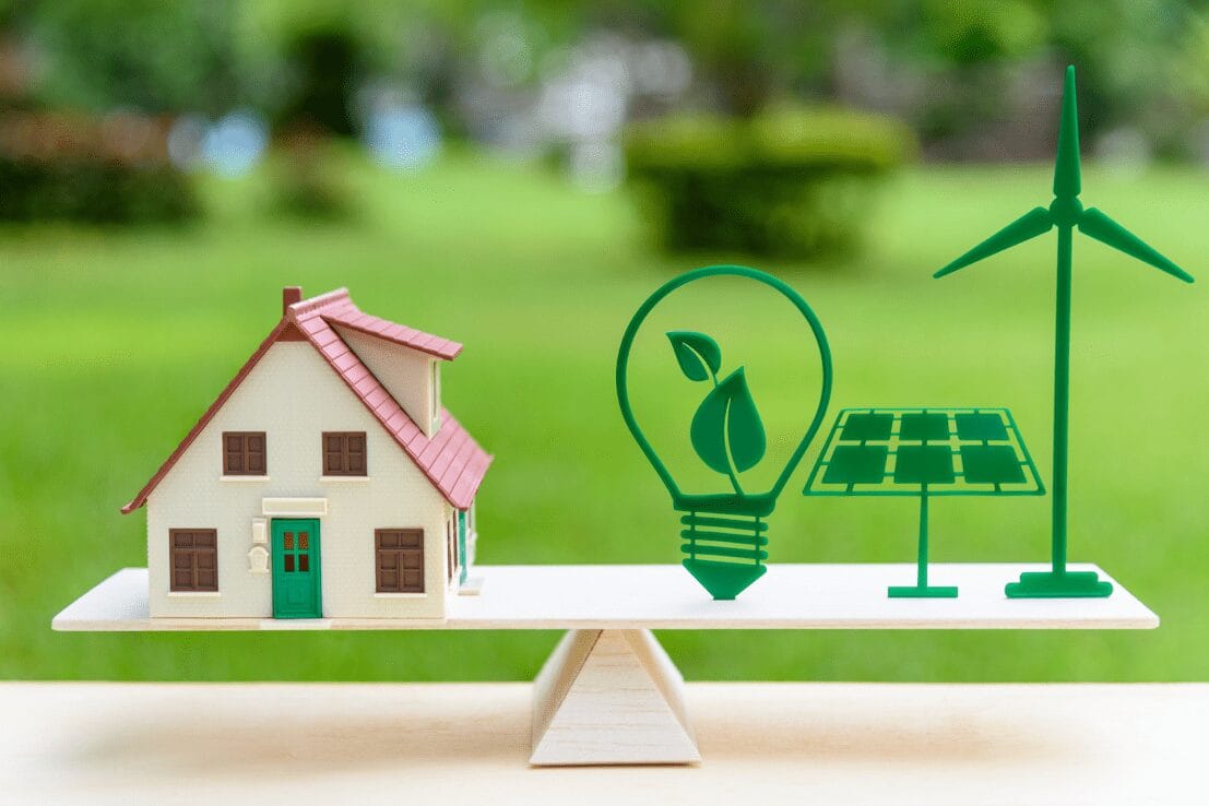Renewable energy icons scaled against a toy house
