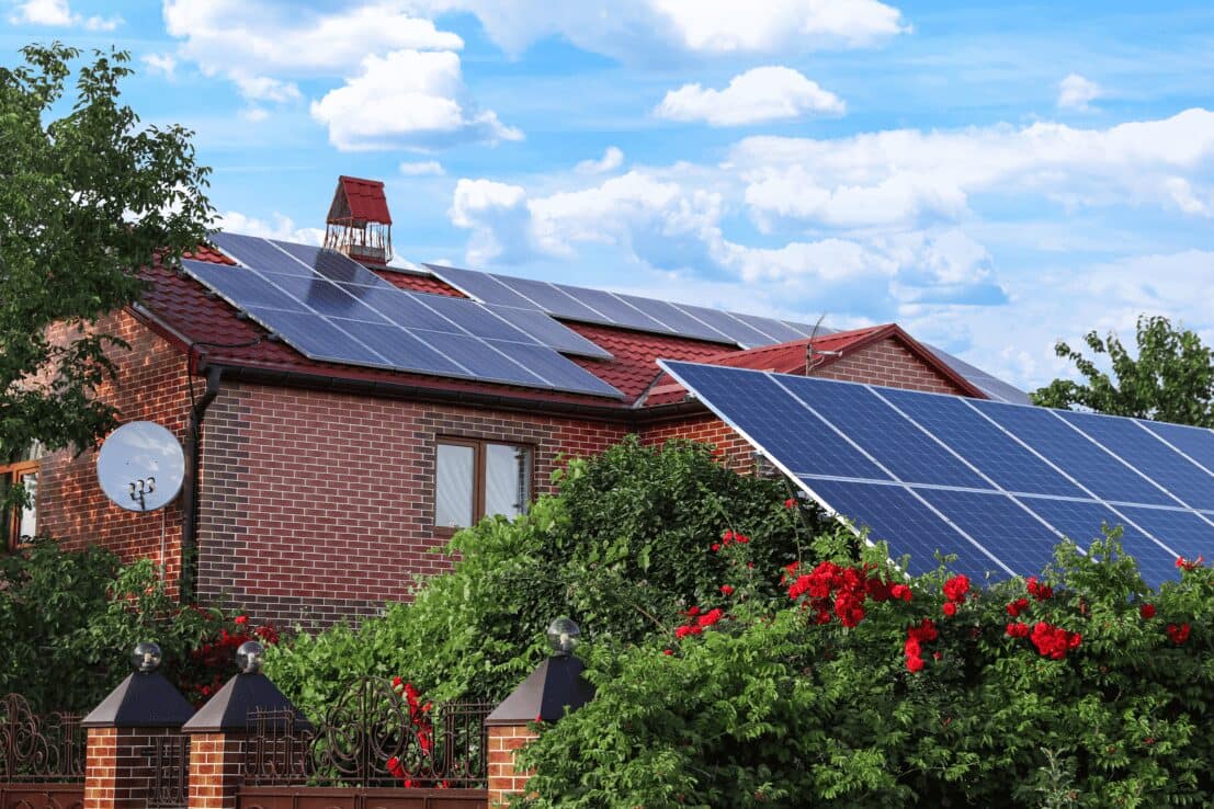 Solar panels on the roof of a house and with panels in the garden