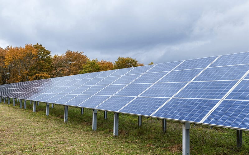 Solar panels in a field on a cloudy day